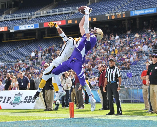 St. Augustine receiver Ryan Harris leaps to haul in a touchdown over a Mission Bay defender during the CIF San Diego Section Division 2 title game in December.