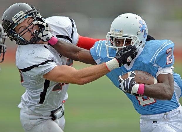 A Father Judge player stiff-arms Archbishop Ryan's Bobby Romano during a Pennsylvania game in October.