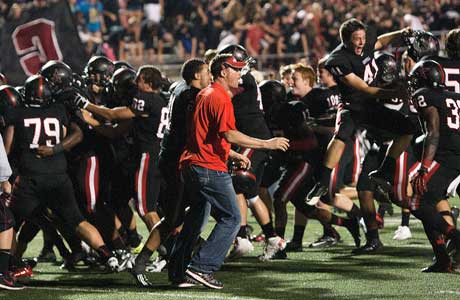 Coppell players and coaches celebrate their victory over Allen in overtime.