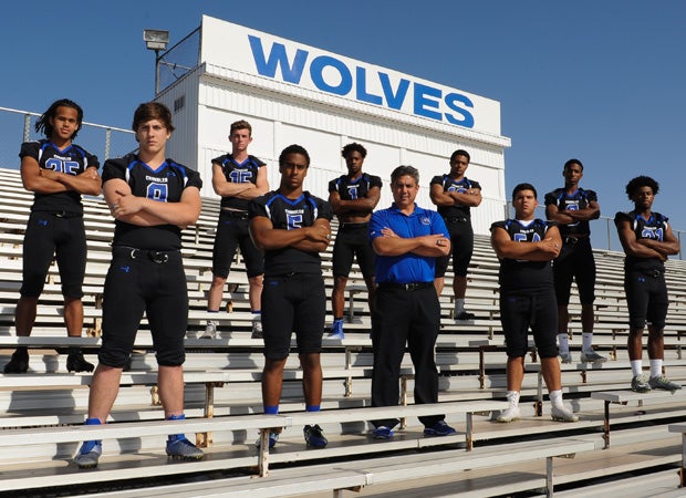 Chandler head coach Shaun Aguano poses for a group shot with nine of his top players.