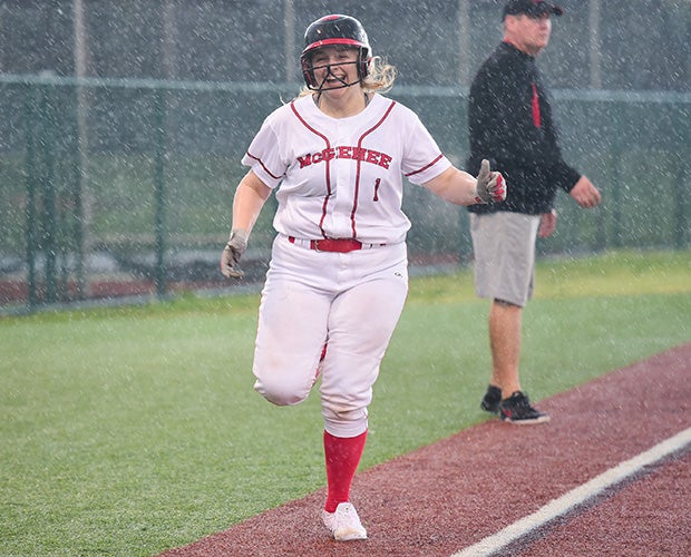 Katie Dunn of McGehee (La.) celebrates hitting a home run against Lusher during a rain storm. 