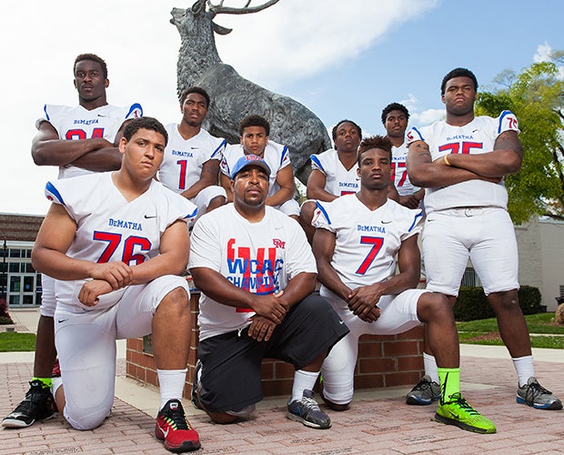 DeMatha head coach Elijah Brooks poses along with eight of his top players during a photo shoot on campus in May.