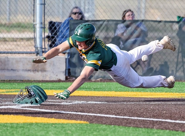 A Pueblo County junior varsity player dives for home plate as the ball squirts away from the catcher. (Photo: David Saul)