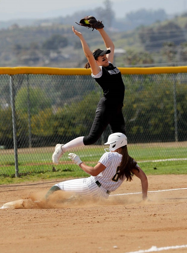 Moorpark's Shae Anderson slides in to third as Oak Park's Kari Sorensen tries to bring the tag down. (Photo: Ron Wilson)