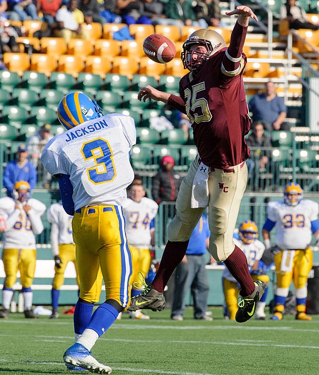 Darren Becker of Wayland-Cochocton (Wayland, N.Y.) leaps to deflect a pass from Aaron Jackson of Cleveland Hill (Cheektowaga, N.Y.).