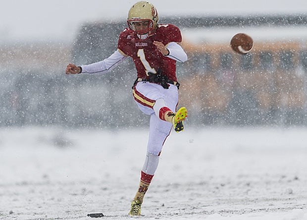 Andrew Matthews of Judge Memorial (Salt Lake City) kicks off during a snow flurry in a game against Manti (Utah).
