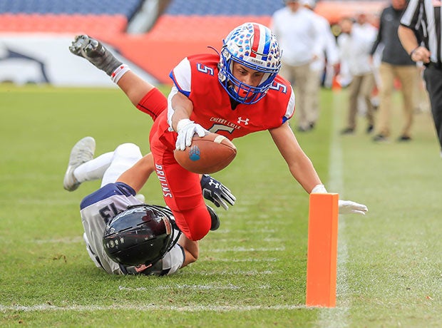 Cherry Creek (Colo.) receiver James Walker II dives for a touchdown against Columbine in the CHSAA 5A state title game at Empower Field at Mile High. 