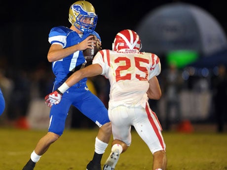 Mater Dei's J.C. Genova bears down on Santa Margarita quarterback Kyle Sweet Friday night. Geonva registered three sacks and a forced fumble.