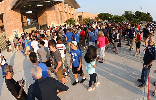 Fans line-up outside Gate A before Friday's night game at Eagle Stadium.
