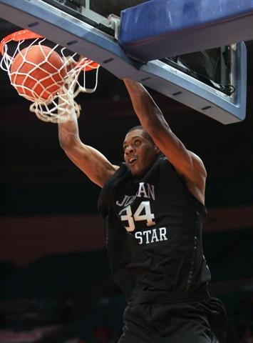 Derrick Favors rocks the rim at the Jordan Brand Classic.
