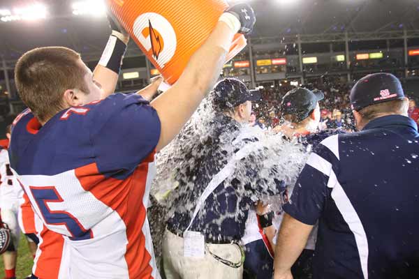Tyler Jamison sneaks up to give head coach Mike Parsons a Gatorade bath.