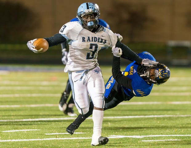 Eleanor Roosevelt (Md.) running back Karl Mofor stiff-arms a defender while scoring on a touchdown run against Wise in the MPSSAA 4A South Regional title game. 