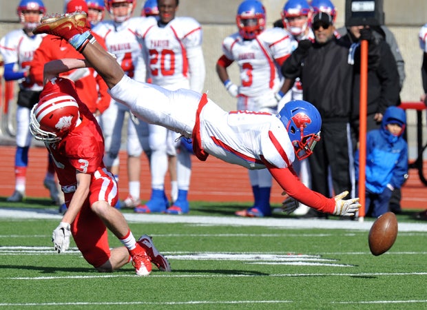 Major Dykes of Grapevine (Texas) upends Parish Episcopal's Dominic Williams while knocking the ball loose during a TAPPS Division 2 quarterfinal playoff game.