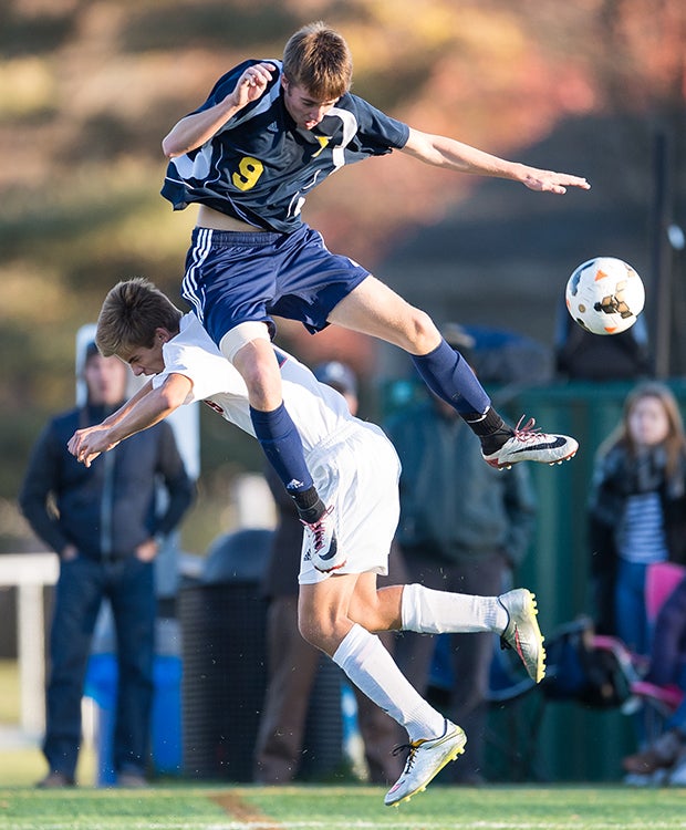 A Xaverian Brothers (Mass.) player (top) and a Wellesley player collide while batting for the ball during an MIAA Division 1 South quarterfinal playoff game.