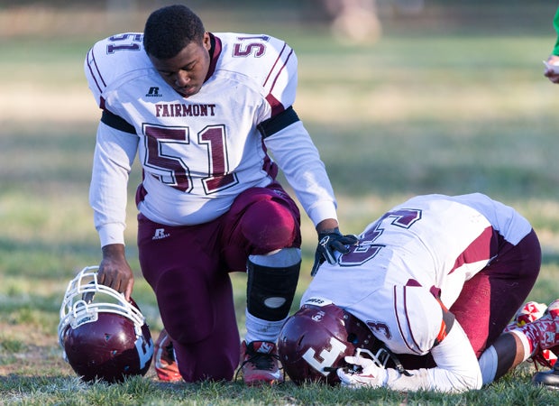 Harry Jennings of Fairmont Heights (Md.) consoles teammate Deshawn Maddox following a loss to Forestville Military Academy in an MPSSAA 1A North semifinal playoff game.