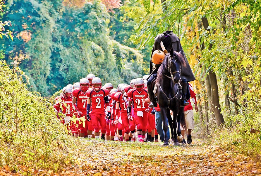 A headless horsemen leads the Sleepy Hollow football team to the field for a 2013 game against Ossining. (PHOTO: Patrick Tewey)