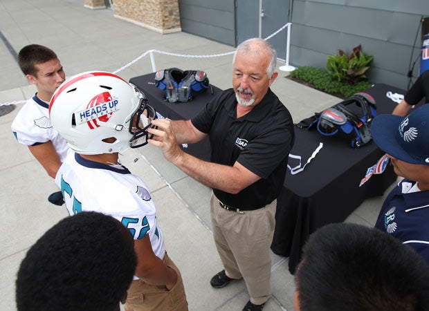 WIAA assistant executive director John Miller assists in a Heads Up Football demonstration at the USAFootball/MaxPreps High School Football Media Day in Seattle.