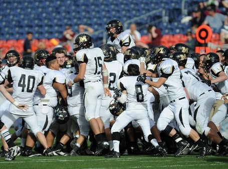 Monarch players react as time expires in the Coyotes' 17-14 win against Denver South in the Class 4A championship game Saturday.