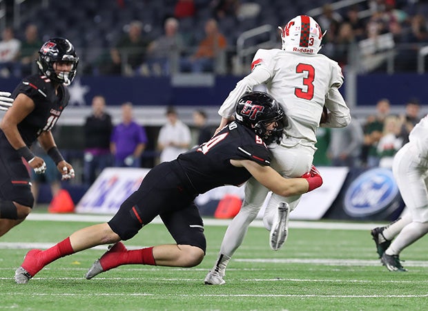 Lake Travis defensive lineman Justin Francis sacks The Woodlands quarterback Eric Schmid.