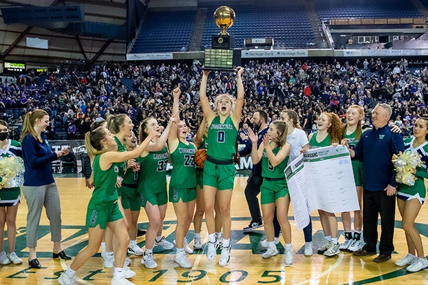 Washington MaxPreps Player of the Year Tatum Thompson of Woodinville hoists the Class 4A state championship trophy.