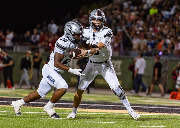 Hamilton quarterback Jax Sculley hands off to running back Devante Roebuck. Sculley threw three touchdown passes in the upset victory. (PHOTO: Steven Davis)