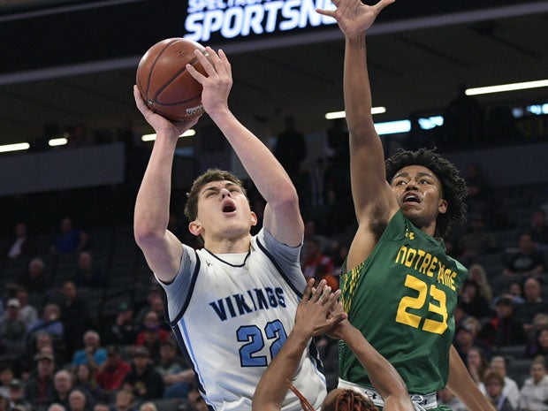 Pleasant Valley's Kevin Kremer (22) battles with Notre Dame's Andrew Gosserand.