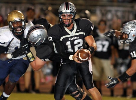 Hamilton quarterback A.J. Thigpen is about to hand the ball to Kevin Walters during a 23-13 win over Desert Vista on Friday night.