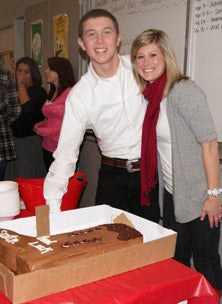 Scotty McCreery with his school's choral
director Meredith Clayton during a send-
off before the American Idol headed to
Hollywood.