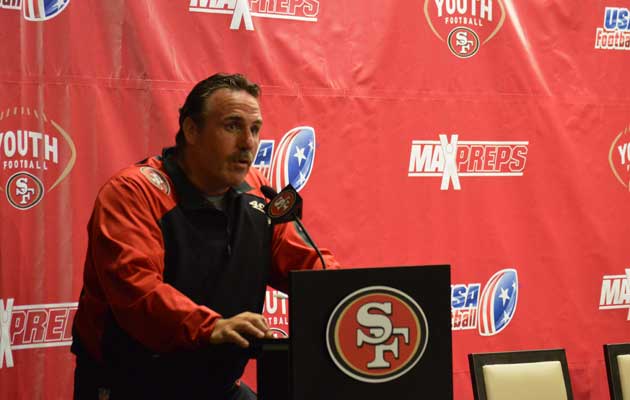 49ers head coach Jim Tomsula offers words of wisdom to the athletes in attendance.