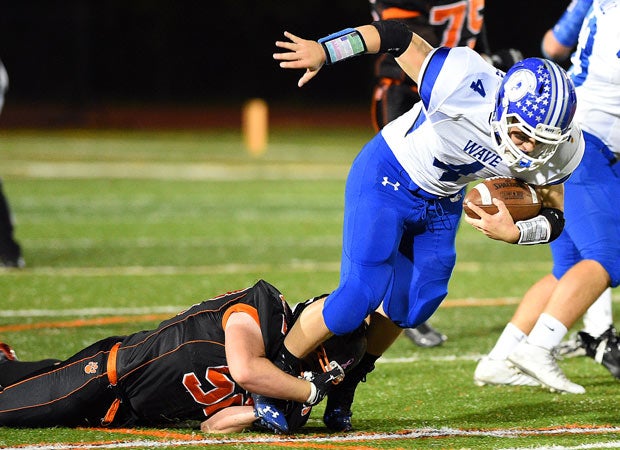 Darien (Conn.) running back Peter Archey is tackled from behind by a Ridgefield defender.