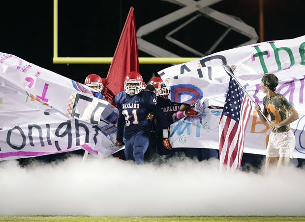 Oakland (Tenn.) linebacker Josh Smith prepares to lead his teammates onto the field before their game against Riverdale.