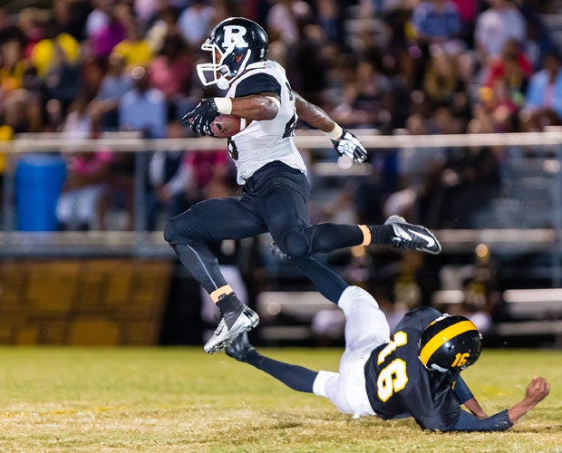 Robinson (Fla.) running back Aivory Foster soars over a Blake defender.