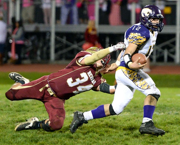Ukiah (Calif.) running back Will Thom-King attempts to elude a diving Cardinal Newman defender.