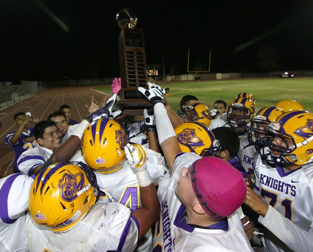 Lynwood (Calif.) players celebrate while hoisting the trophy following their victory over Firebaugh in the City Classic.