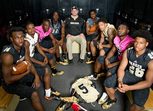 Head coach Jayson West (center) is surrounded by a wealth of outstanding talent.