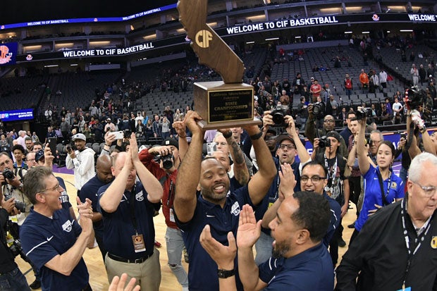 Sierra Canyon boys coach Andrew Chevalier holds up the Open Division trophy for a second straight year. 