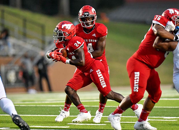 Dematrius Davis (4) hands the ball to Brannon Davis Jr. (24), who each scored rushing touchdowns in North Shore's 38-21 win over Shadow Creek. 