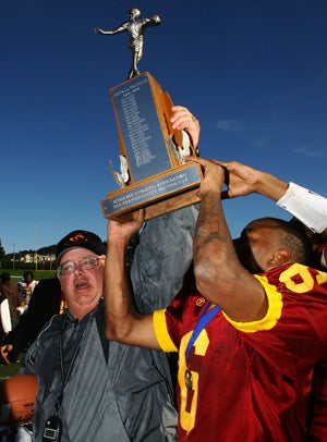 Phil Ferrigno (left) helps hold up the trophy
for winning a fifth San Francisco Section
title in 2012.