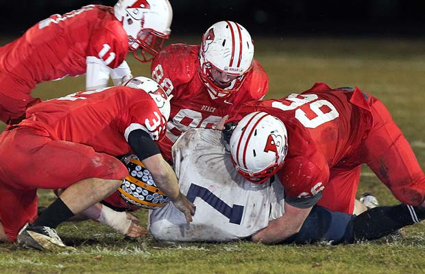 Four Point Pleasant Beach defenders assist on a tackle during their semifinal playoff loss to Florence.