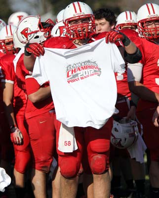 Sean Struncius holds up a championship T-shirt
following his team's win on Thanksgiving Day. 