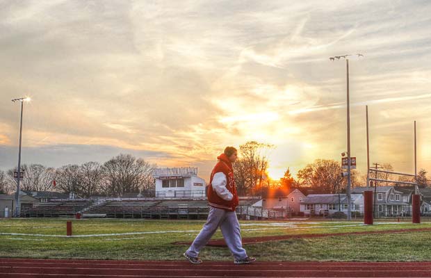 An athlete walks along the track at Donald T. Fioretti Field. 