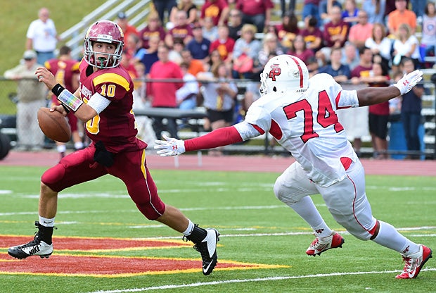 Kevin Trefz of St. Joseph (Trumbull, Conn.) attempts to evade Fairfield Prep (Conn.) pass rusher Nathan Miller.