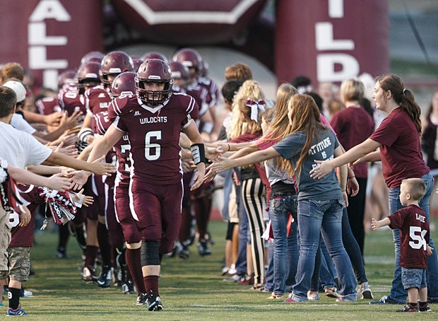 Callisburg (Gainesville, Texas) receives high fives from fans during its entrance against Tom Bean (Texas).
