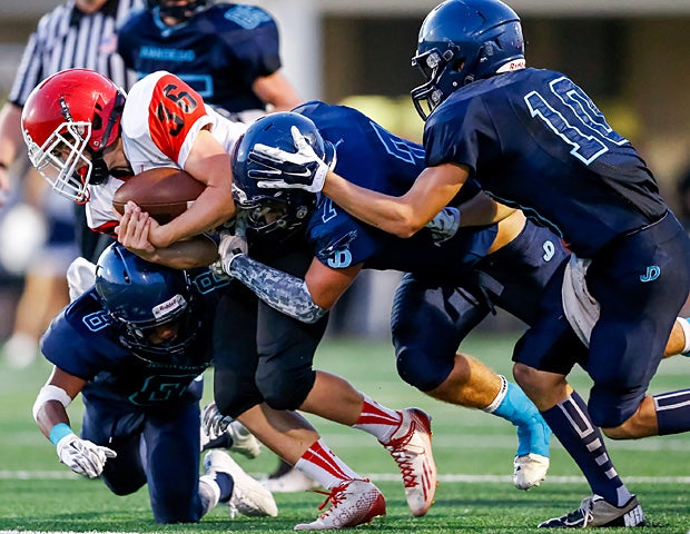 Gage Kaneko of Bear River (Garland, Utah) gets swarmed by a pack of Juan Diego Catholic (Draper, Utah) tacklers.