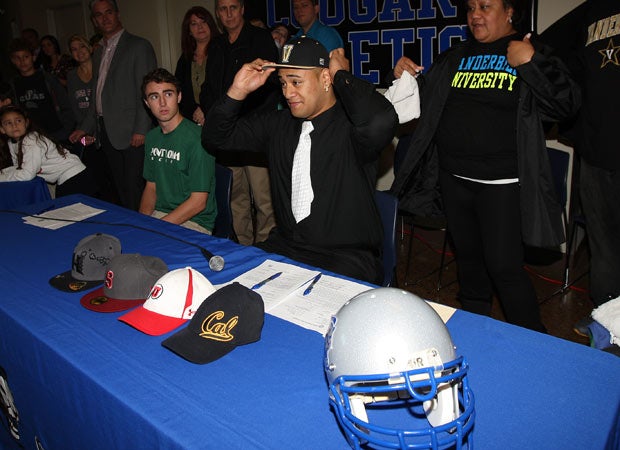 Nifae Lealao Jr. makes his college choice known by putting on a Vanderbilt cap during a signing day ceremony at Capital Christian High School on Wednesday morning.