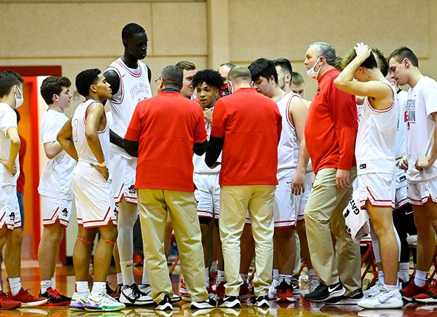 Bol looks down from above on his teammates during a time out.