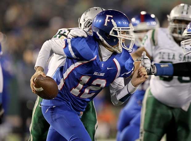 Jake Browning attempts to escape pressure from De La Salle in last year's Open Division final. The Bulldogs will need to protect him much better this season after De La Salle sacked him six times — Folsom had allowed only nine all season coming into the game - last season. Browning was also forced into three interceptions.