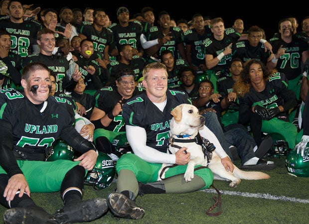 Luke and Astro celebrate with teammates following a recent home victory.