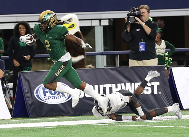 DeSoto receiver Laviska Shenault leaps over a defender while scoring on a touchdown catch during the third quarter.