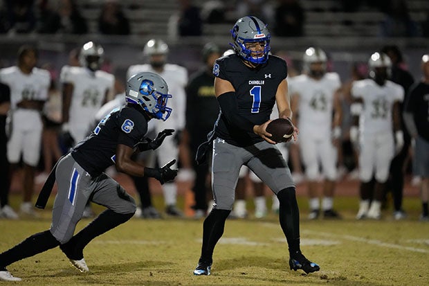 Chandler's Dylan Raiola hands off to Ca'lil Valentine in the first half of the Wolves' game Friday against Basha. (Photo: David Venezia)